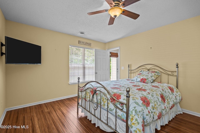 7100 Farrington Farms Dr, Wilmington, NC 28411 - bedroom with baseboards, wood finished floors, a textured ceiling, and a ceiling fan
