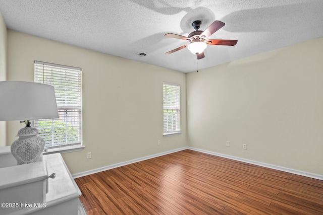 7100 Farrington Farms Dr, Wilmington, NC 28411 - unfurnished office with ceiling fan, plenty of natural light, wood finished floors, baseboards, and a textured ceiling