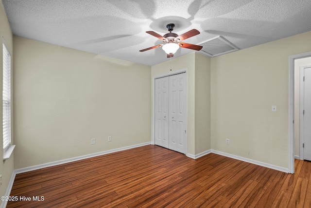 7100 Farrington Farms Dr, Wilmington, NC 28411 - unfurnished bedroom with wood finished floors, a closet, baseboards, a textured ceiling, and ceiling fan