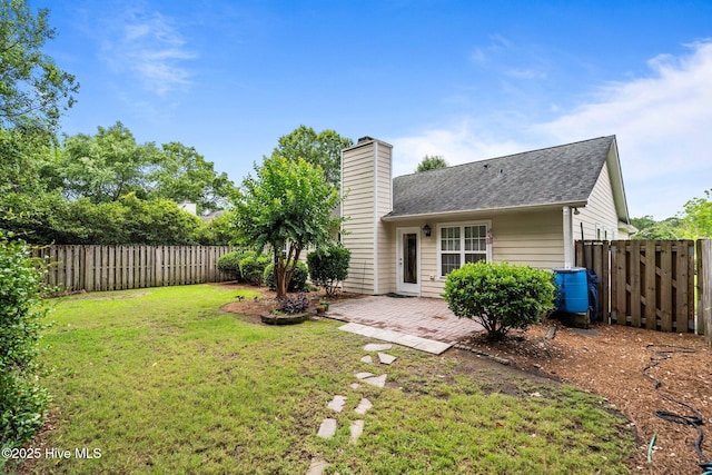 7100 Farrington Farms Dr, Wilmington, NC 28411 - rear view of house featuring roof with shingles, a patio area, and a chimney