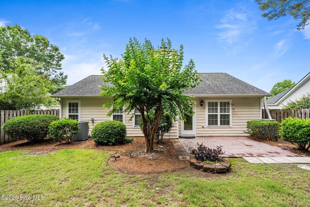 7100 Farrington Farms Dr, Wilmington, NC 28411 - back of property with a shingled roof, a patio area, and central AC unit