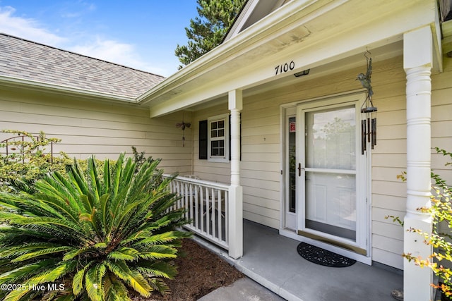 7100 Farrington Farms Dr, Wilmington, NC 28411 - view of exterior entry with covered porch and roof with shingles