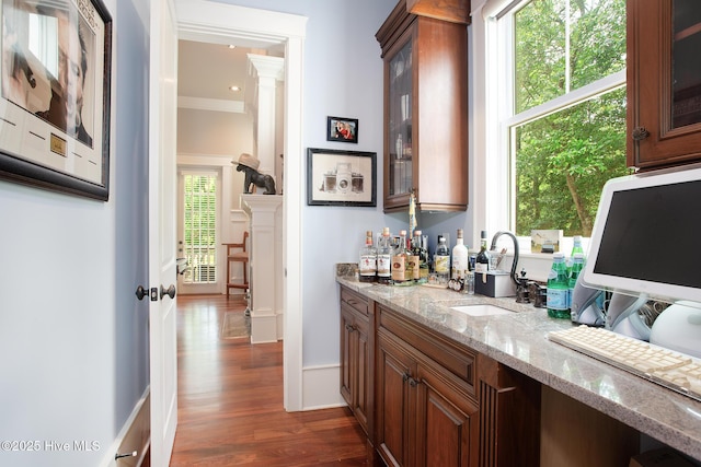 1001 Appaloosa Trl, Wilmington, NC 28411 - indoor bar featuring dark wood-style flooring, ornate columns, and ornamental molding