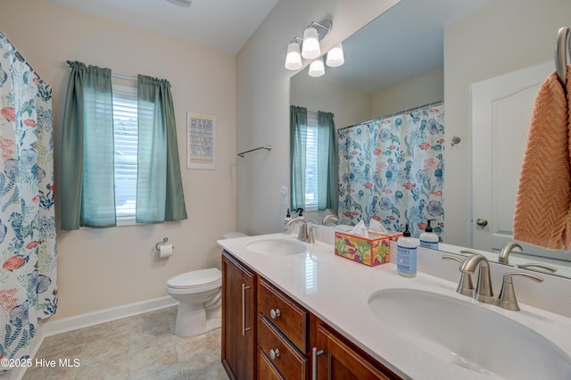 14 Thrush Trl, Hampstead, NC 28443 - bathroom with double vanity, toilet, and baseboards