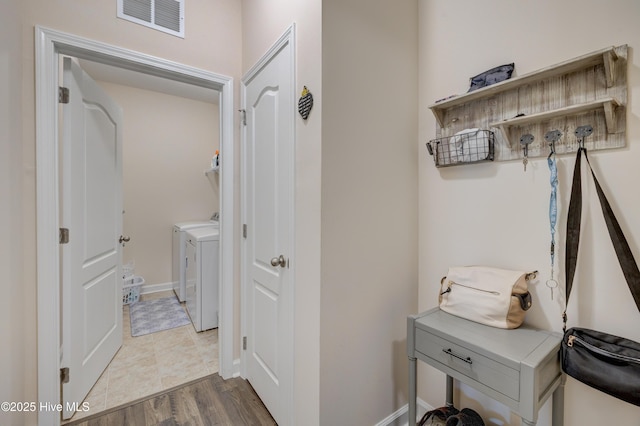 14 Thrush Trl, Hampstead, NC 28443 - hallway featuring washing machine and clothes dryer and wood finished floors