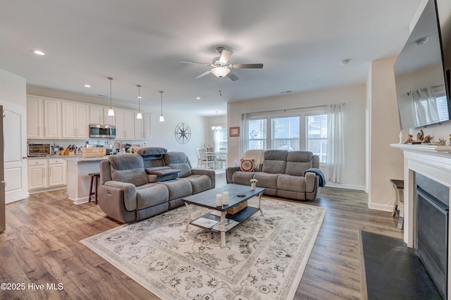 14 Thrush Trl, Hampstead, NC 28443 - living area with ceiling fan, wood finished floors, recessed lighting, a fireplace with flush hearth, and baseboards