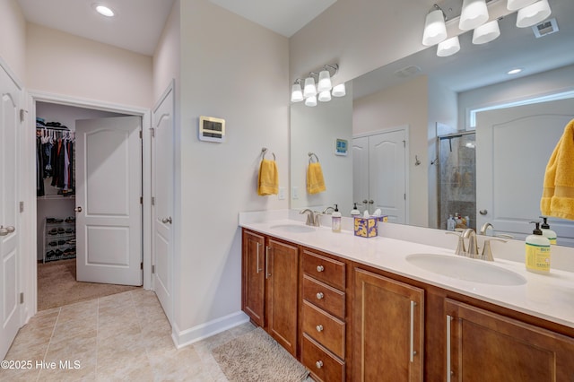 14 Thrush Trl, Hampstead, NC 28443 - full bath featuring a stall shower, double vanity, a walk in closet, and tile patterned flooring