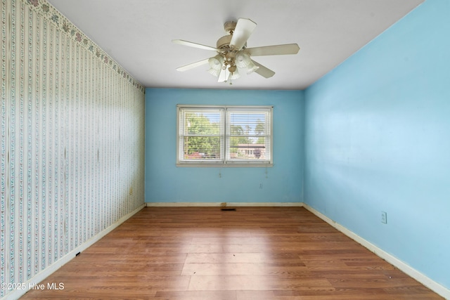 525 Mohican Trl, Wilmington, NC 28409 - empty room featuring wood finished floors, a ceiling fan, and baseboards