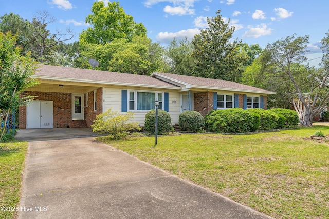 525 Mohican Trl, Wilmington, NC 28409 - ranch-style home with driveway, brick siding, a front lawn, and an attached carport