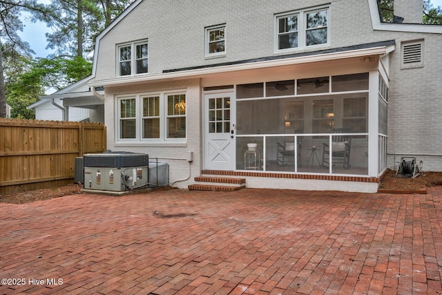 3504 Sheffield Dr, Rocky Mount, NC 27803 - back of house with a sunroom, entry steps, a patio, cooling unit, and brick siding
