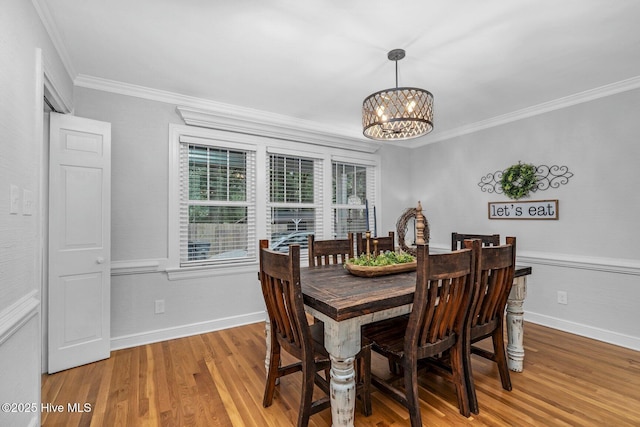 3504 Sheffield Dr, Rocky Mount, NC 27803 - dining area featuring a chandelier, light wood-type flooring, crown molding, and baseboards