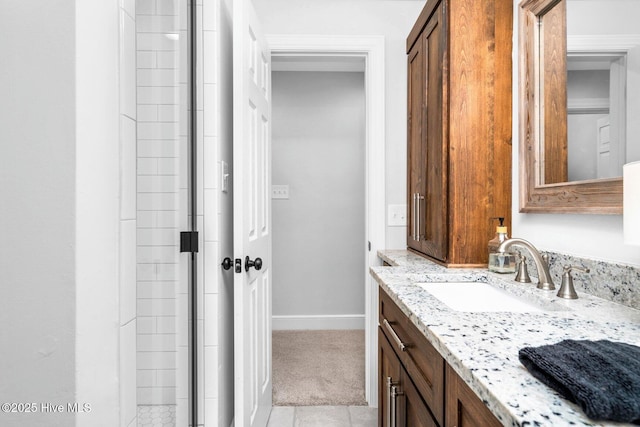 3504 Sheffield Dr, Rocky Mount, NC 27803 - bathroom featuring vanity, baseboards, tiled shower, and tile patterned floors
