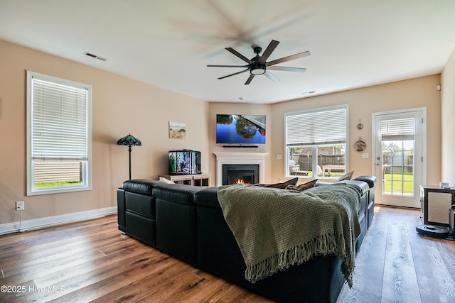 1187 S Brook Rd, Winnabow, NC 28479 - living room featuring a ceiling fan, hardwood / wood-style flooring, and a lit fireplace