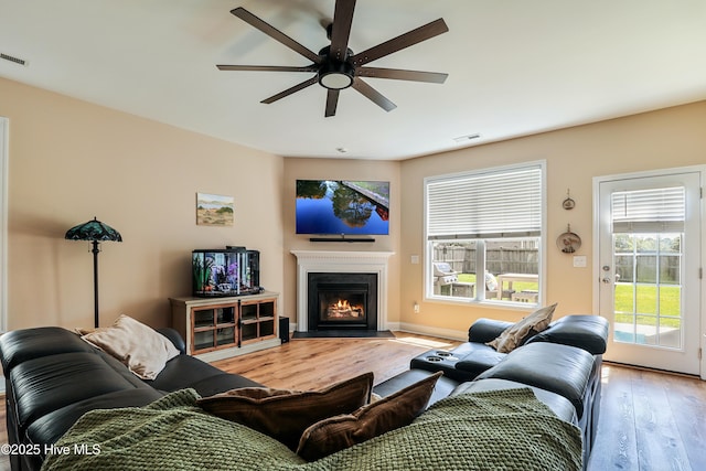 1187 S Brook Rd, Winnabow, NC 28479 - living room with light wood finished floors, a ceiling fan, and a fireplace with flush hearth