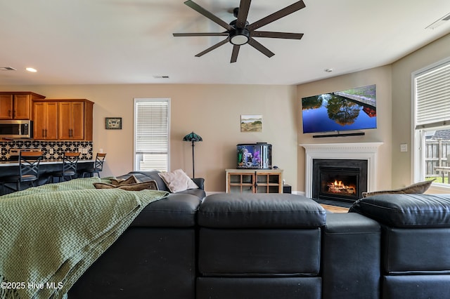 1187 S Brook Rd, Winnabow, NC 28479 - living area with ceiling fan, recessed lighting, and a lit fireplace