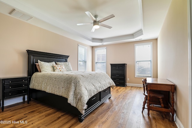 1187 S Brook Rd, Winnabow, NC 28479 - bedroom with a raised ceiling, light wood finished floors, and a ceiling fan