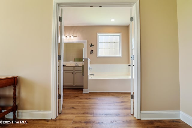 1187 S Brook Rd, Winnabow, NC 28479 - bathroom featuring hardwood / wood-style floors, vanity, and a garden tub