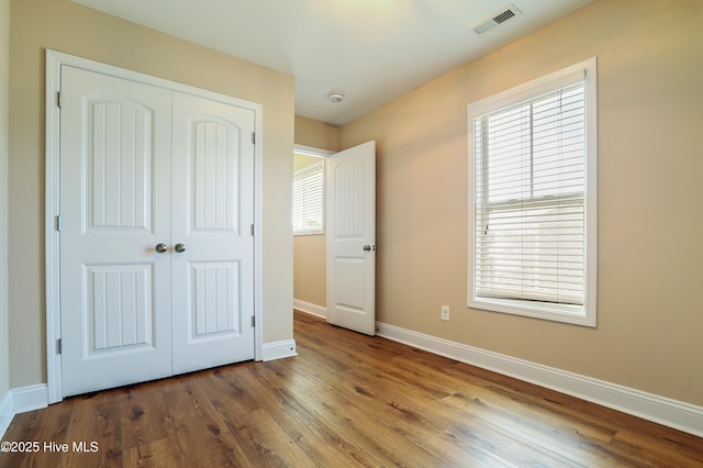 1187 S Brook Rd, Winnabow, NC 28479 - unfurnished bedroom featuring a closet and wood finished floors