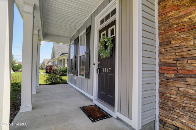 1187 S Brook Rd, Winnabow, NC 28479 - doorway to property with a porch and board and batten siding