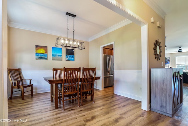 1187 S Brook Rd, Winnabow, NC 28479 - dining area with wood finished floors, crown molding, and a chandelier