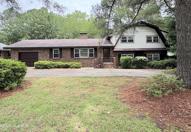 1102 Raleigh Road Parkway W, Wilson, NC 27896 - tri-level home with asphalt driveway, a garage, brick siding, a chimney, and a front yard