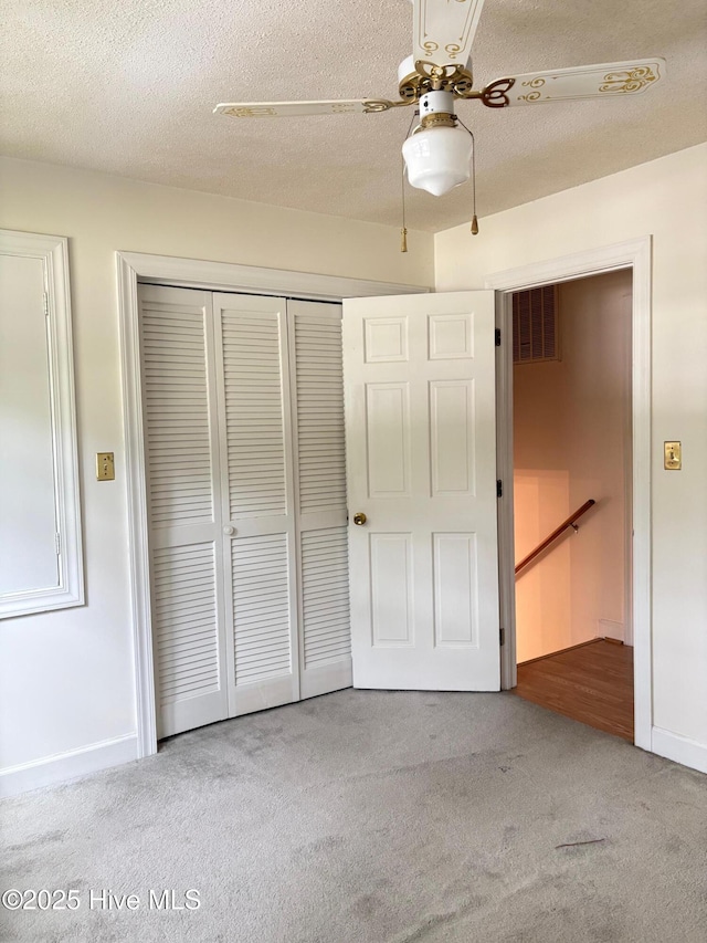 1102 Raleigh Road Parkway W, Wilson, NC 27896 - unfurnished bedroom with carpet flooring, a closet, baseboards, ceiling fan, and a textured ceiling