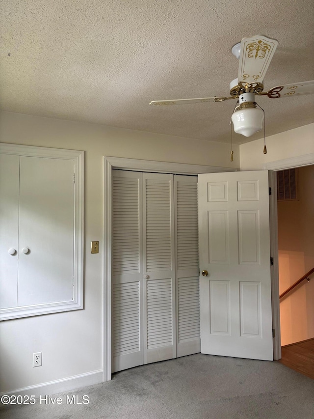 1102 Raleigh Road Parkway W, Wilson, NC 27896 - unfurnished bedroom with carpet floors, a textured ceiling, a ceiling fan, and baseboards