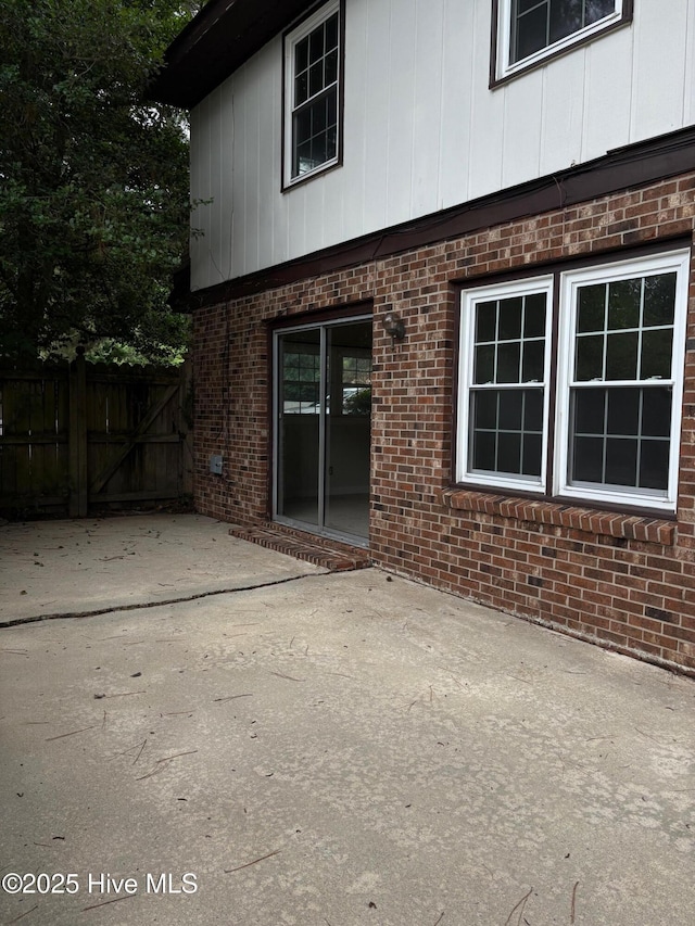 1102 Raleigh Road Parkway W, Wilson, NC 27896 - view of side of property with brick siding, a patio, and a gate
