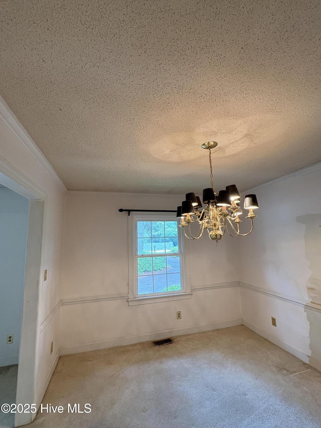 1102 Raleigh Road Parkway W, Wilson, NC 27896 - carpeted spare room with a chandelier, a textured ceiling, ornamental molding, and baseboards