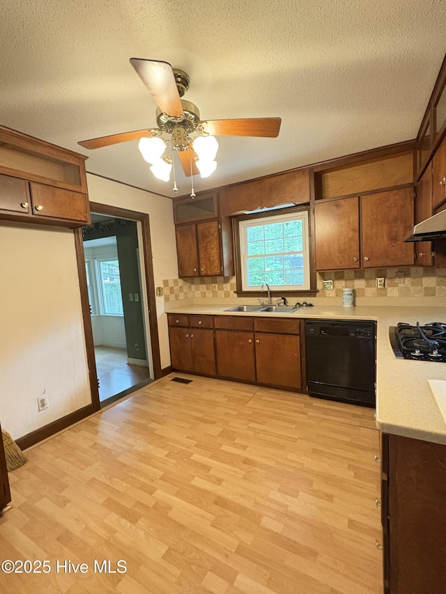 1102 Raleigh Road Parkway W, Wilson, NC 27896 - kitchen featuring black appliances, a sink, backsplash, light countertops, and light wood-style floors