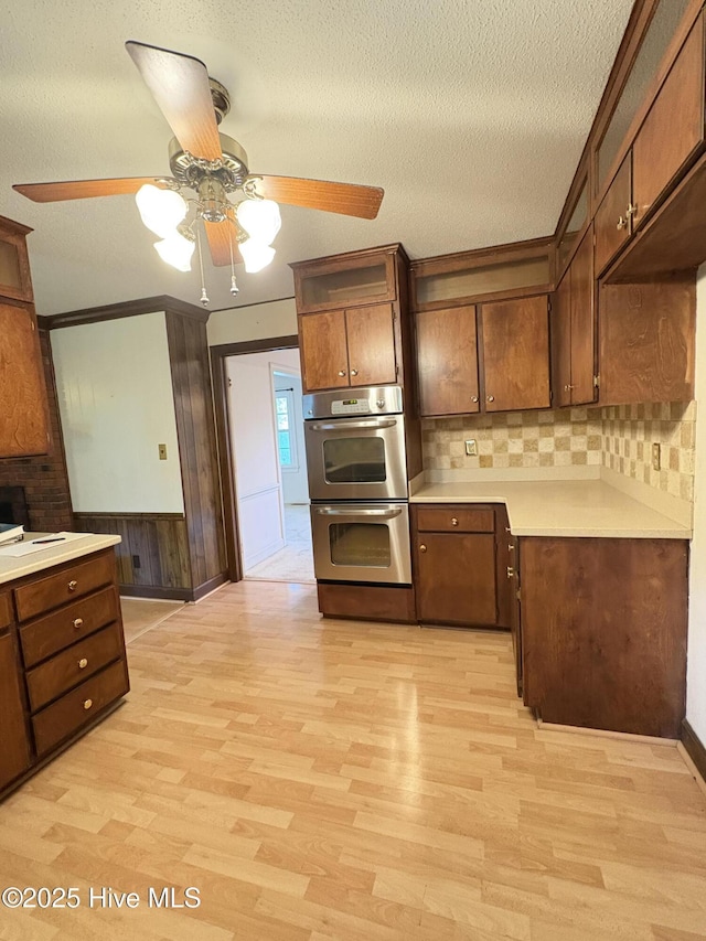 1102 Raleigh Road Parkway W, Wilson, NC 27896 - kitchen featuring double oven, ceiling fan, light wood-style floors, light countertops, and a textured ceiling