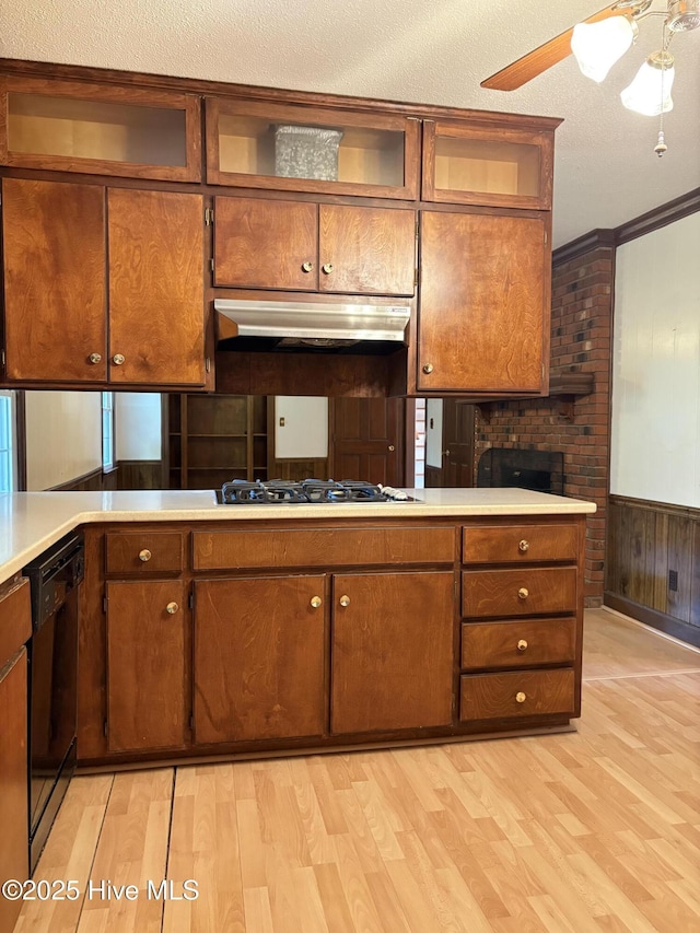 1102 Raleigh Road Parkway W, Wilson, NC 27896 - kitchen with under cabinet range hood, dishwasher, light wood-style flooring, light countertops, and gas stovetop