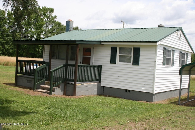 1819 Thirteen Bridges Rd, Enfield, NC 27823 - back of house featuring crawl space, a yard, metal roof, a chimney, and a detached carport