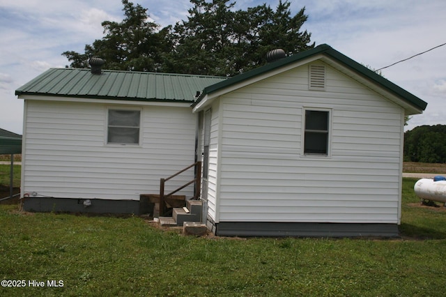 1819 Thirteen Bridges Rd, Enfield, NC 27823 - rear view of property featuring a lawn, entry steps, and metal roof