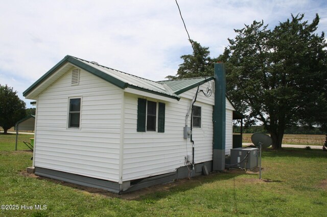 1819 Thirteen Bridges Rd, Enfield, NC 27823 - view of home's exterior featuring a lawn, cooling unit, and metal roof