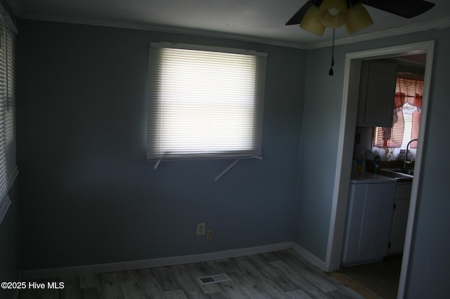 1819 Thirteen Bridges Rd, Enfield, NC 27823 - empty room with ornamental molding, ceiling fan, light wood-type flooring, a sink, and baseboards