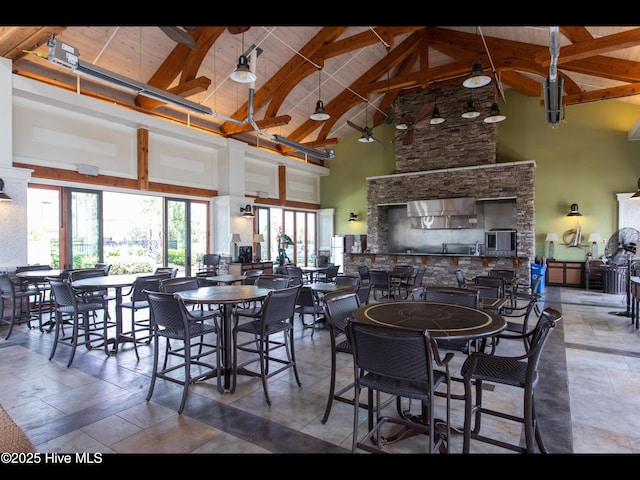 2385 Red Birch Trl NE, Leland, NC 28451 - dining space with high vaulted ceiling, wood ceiling with exposed beams, and stone tile flooring