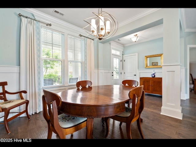 2385 Red Birch Trl NE, Leland, NC 28451 - dining space with a chandelier, wainscoting, dark wood finished floors, crown molding, and a decorative wall