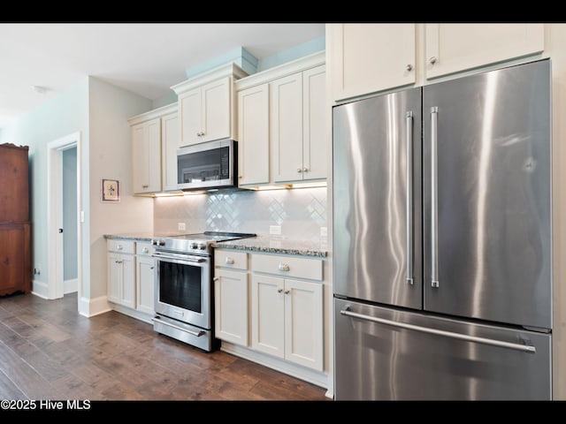 2385 Red Birch Trl NE, Leland, NC 28451 - kitchen featuring high end appliances, dark wood-style floors, backsplash, baseboards, and white cabinetry