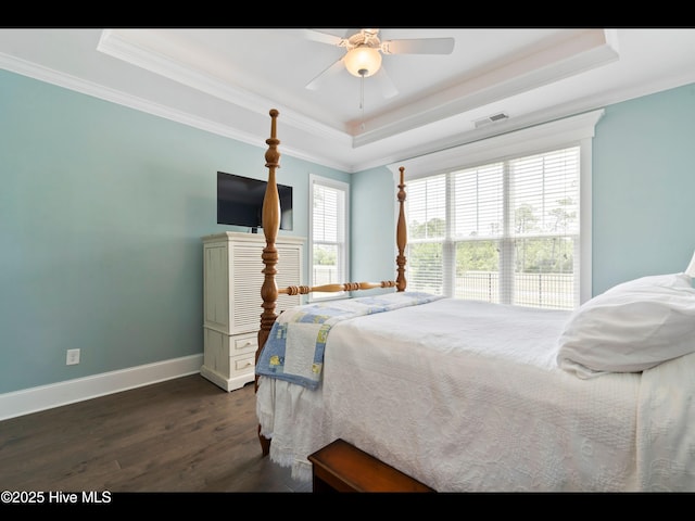 2385 Red Birch Trl NE, Leland, NC 28451 - bedroom with a raised ceiling, dark wood-style flooring, crown molding, baseboards, and ceiling fan