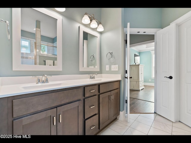 2385 Red Birch Trl NE, Leland, NC 28451 - bathroom featuring double vanity, baseboards, and marble look tiles