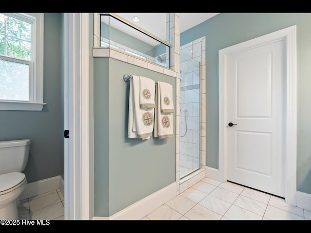 2385 Red Birch Trl NE, Leland, NC 28451 - full bathroom with marble look tile flooring, baseboards, toilet, and walk in shower