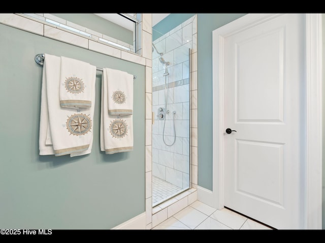 2385 Red Birch Trl NE, Leland, NC 28451 - bathroom featuring a tile shower, tile patterned flooring, and baseboards