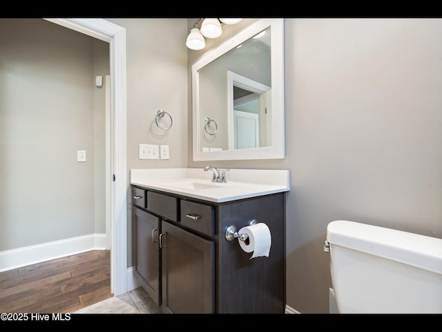 2385 Red Birch Trl NE, Leland, NC 28451 - half bathroom with toilet, vanity, wood finished floors, and baseboards