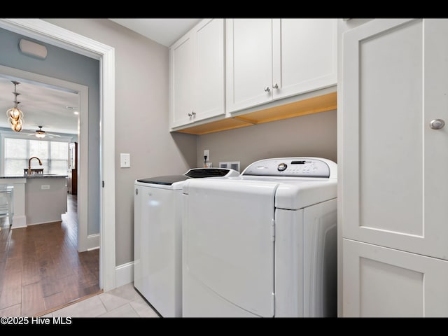 2385 Red Birch Trl NE, Leland, NC 28451 - washroom with cabinet space, separate washer and dryer, baseboards, and light wood-style flooring