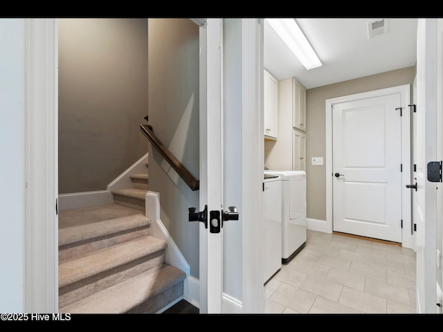 2385 Red Birch Trl NE, Leland, NC 28451 - laundry room featuring washing machine and clothes dryer, cabinet space, baseboards, and light tile patterned floors