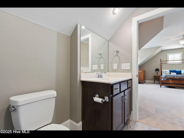 2385 Red Birch Trl NE, Leland, NC 28451 - bathroom with toilet, vaulted ceiling, vanity, a ceiling fan, and baseboards
