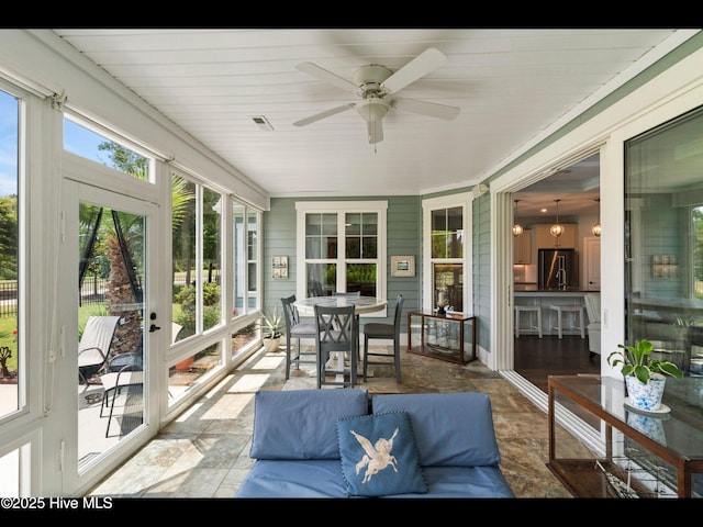 2385 Red Birch Trl NE, Leland, NC 28451 - sunroom / solarium featuring stone finish floors, ceiling fan, and outdoor lounge area