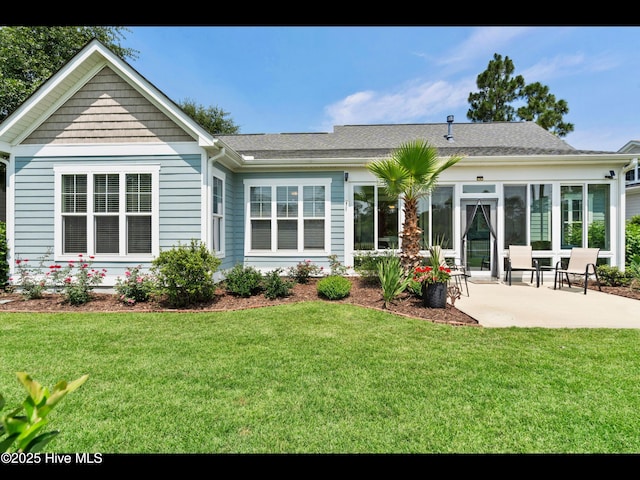2385 Red Birch Trl NE, Leland, NC 28451 - rear view of house featuring a patio, a lawn, a sunroom, and a shingled roof