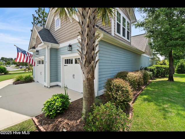 2385 Red Birch Trl NE, Leland, NC 28451 - view of side of home featuring driveway, a yard, a shingled roof, and an attached garage